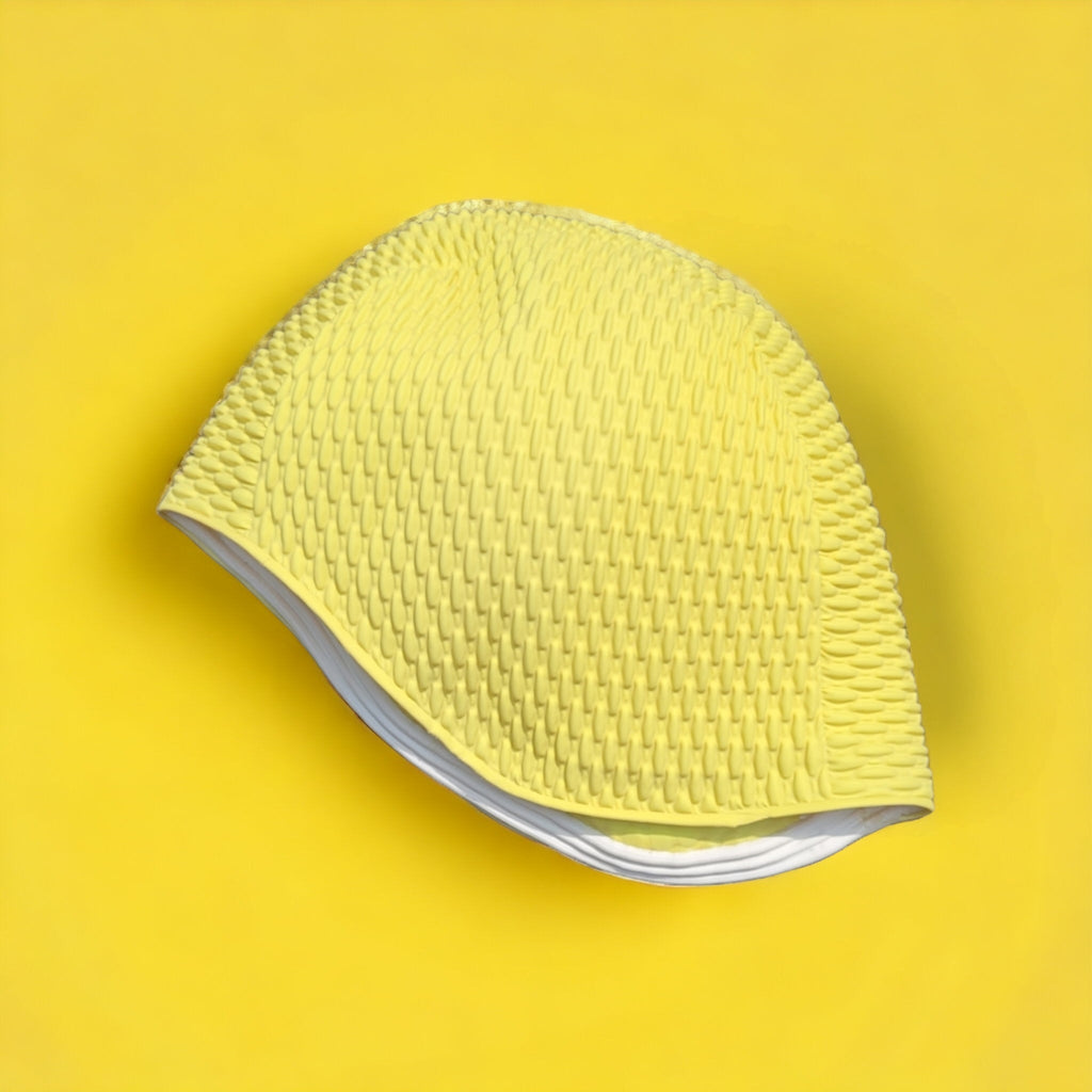 yellow bubble swim cap on a yellow background Fine Saratoga UK swim cap stockist